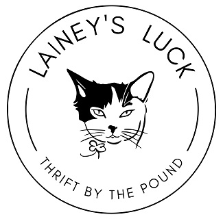 the Lainey's luck logo: a drawing of a cat's head in a circle, with the name Lainey's Luck at the top and Thrift By The Pound around the bottom of the circle