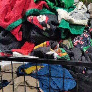 a bin overflowing with xmas sweaters