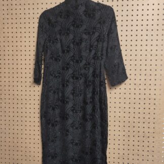 handmade shimmery dress on a hanger