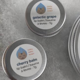 two tubs of lip balm 7g each, one is cherry balm and the other galactic grape