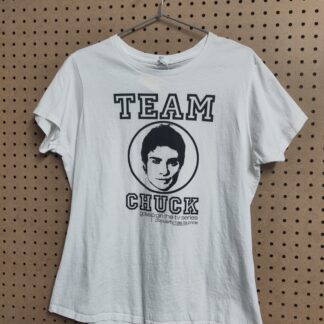white tshirt on a peg board background, TEAM Chuck in black letters with the face of Chuck from gossip girl in the centre