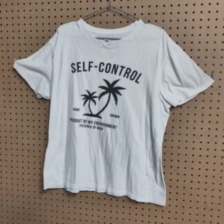 white tshirt on a brown peg board background, black letttering and a palm tree on the shirt, lettering reads Self Control Home Grown Product of My Environment Presence of mind